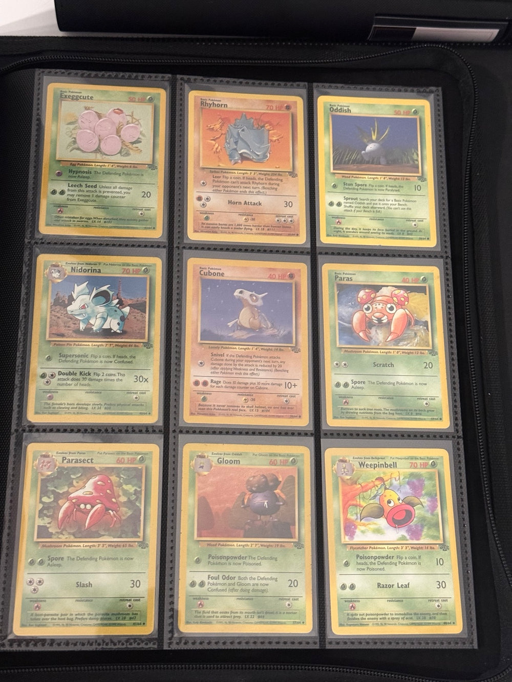 Nine additional English Jungle cards in a binder page — actual cards included